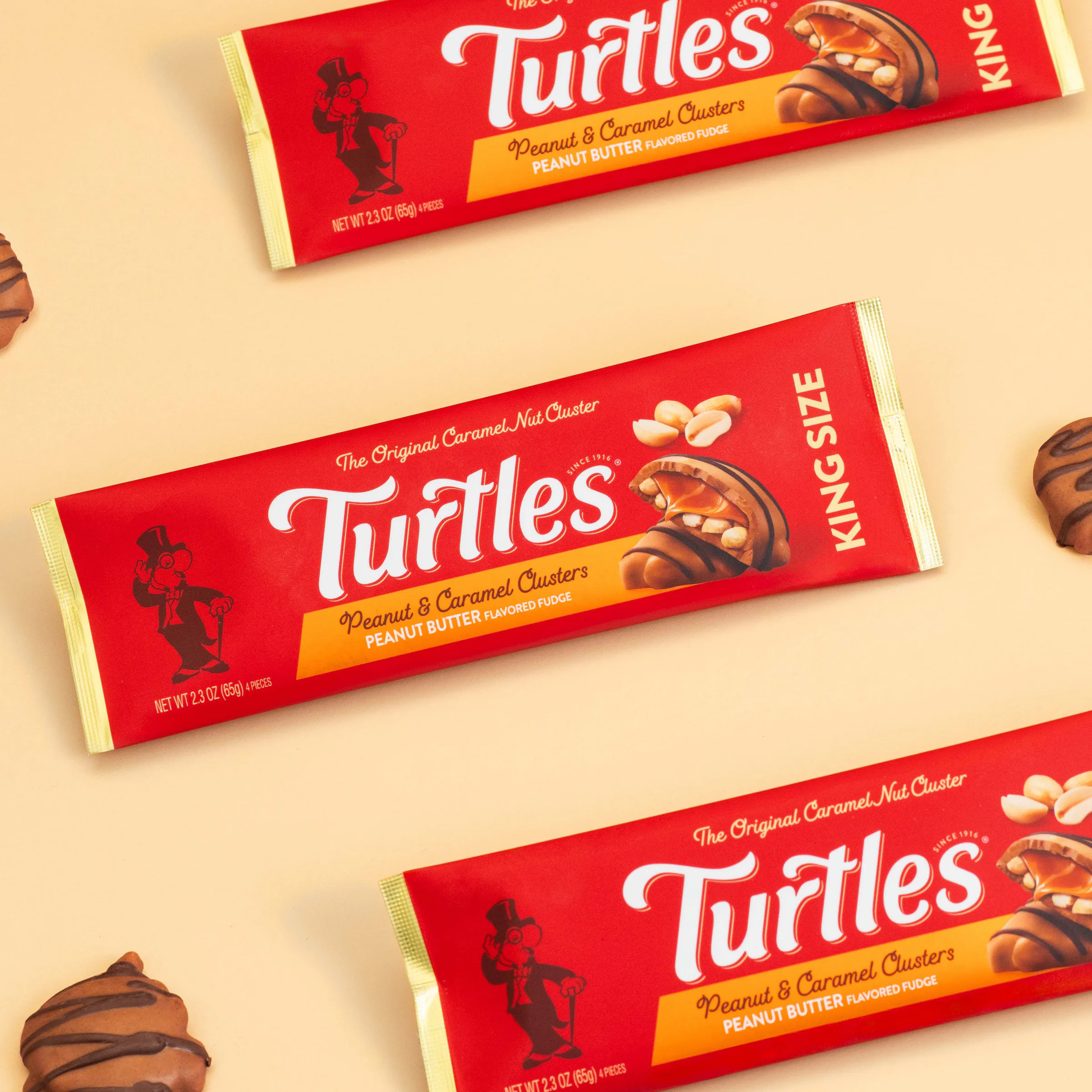 Turtles King Size bars on a peach background, with chocolate clusters