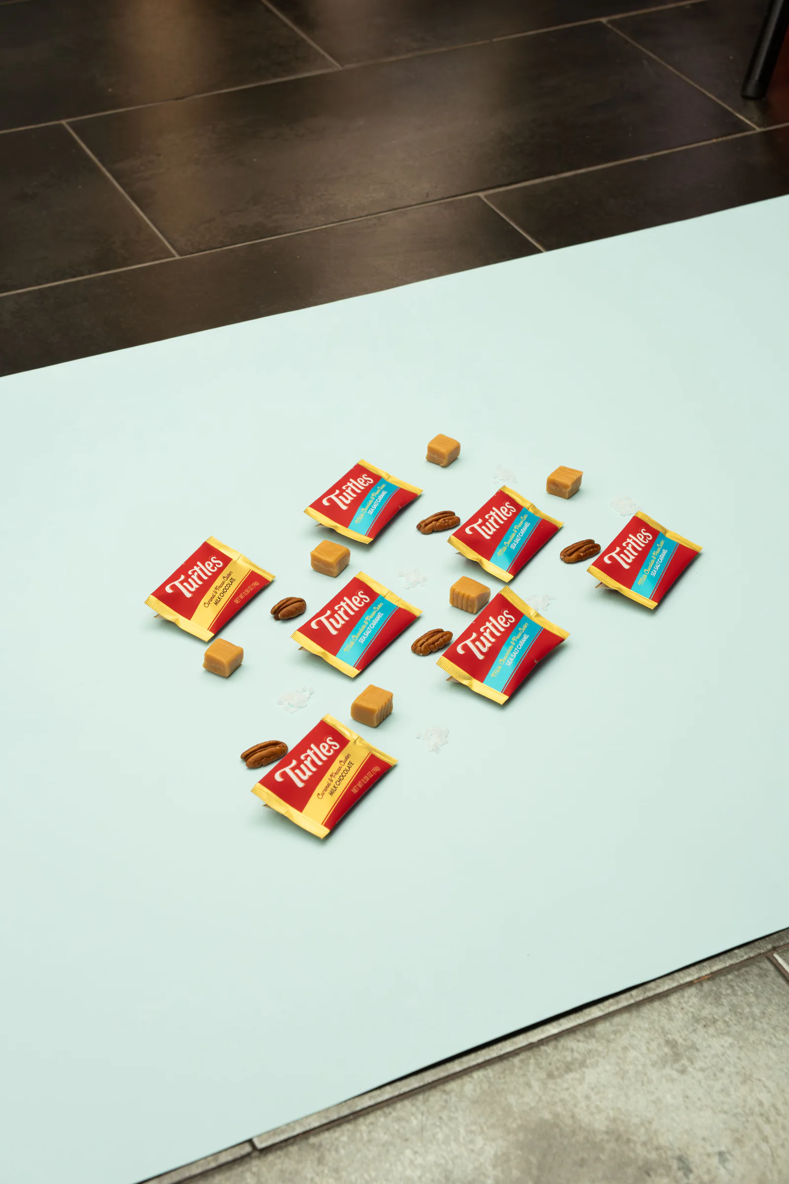 Turtles minis, pecans and caramels on a mint backdrop