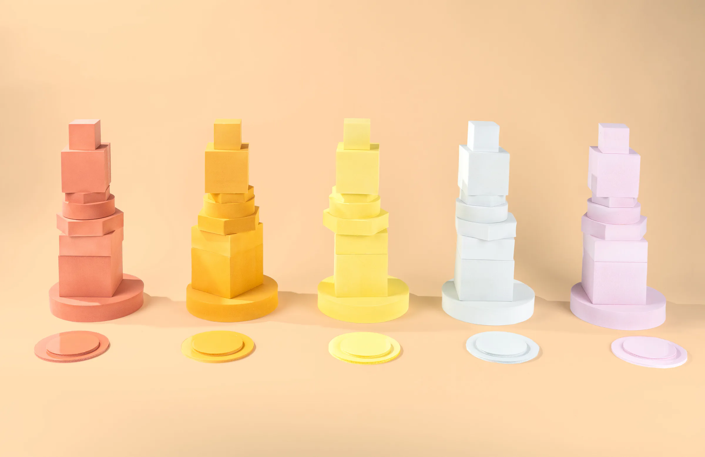 Pastel posing blocks stacked on a peach set
